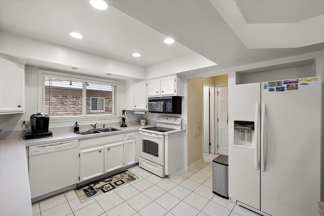 kitchen featuring sink, white cabinets, and white appliances