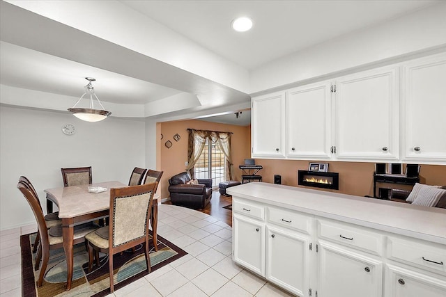 kitchen with white cabinetry, pendant lighting, and light tile patterned floors