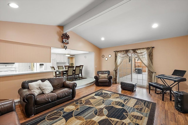 living room with lofted ceiling with beams, wood-type flooring, and plenty of natural light