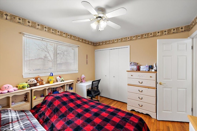 bedroom featuring ceiling fan, a closet, and light hardwood / wood-style flooring