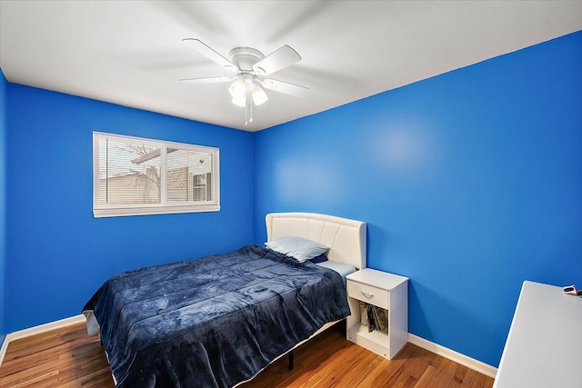 bedroom featuring hardwood / wood-style flooring and ceiling fan