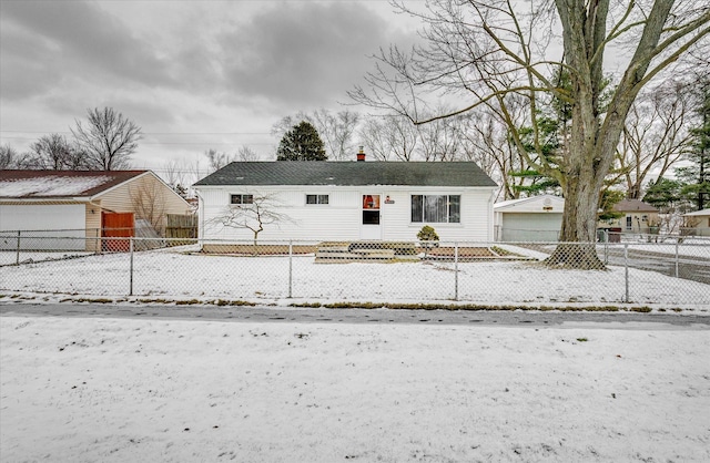 view of front of property featuring a garage and an outdoor structure