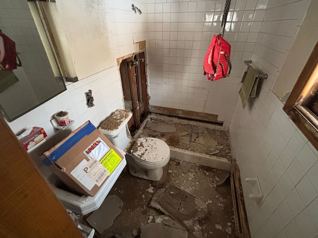 bathroom featuring toilet and tile walls