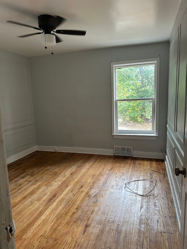 unfurnished room with ceiling fan and light wood-type flooring