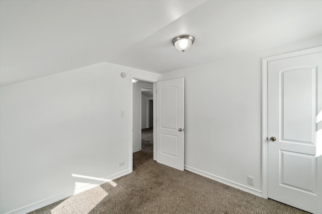 additional living space featuring dark colored carpet