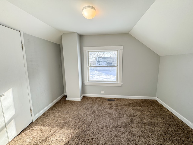 bonus room featuring carpet floors and lofted ceiling