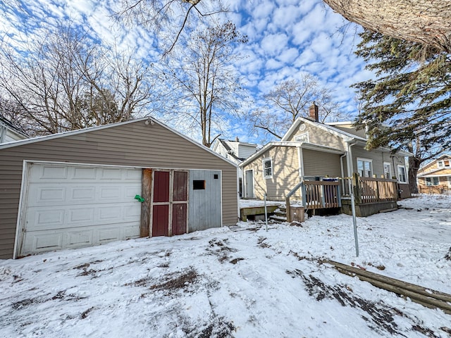 view of front of property with a wooden deck and a garage