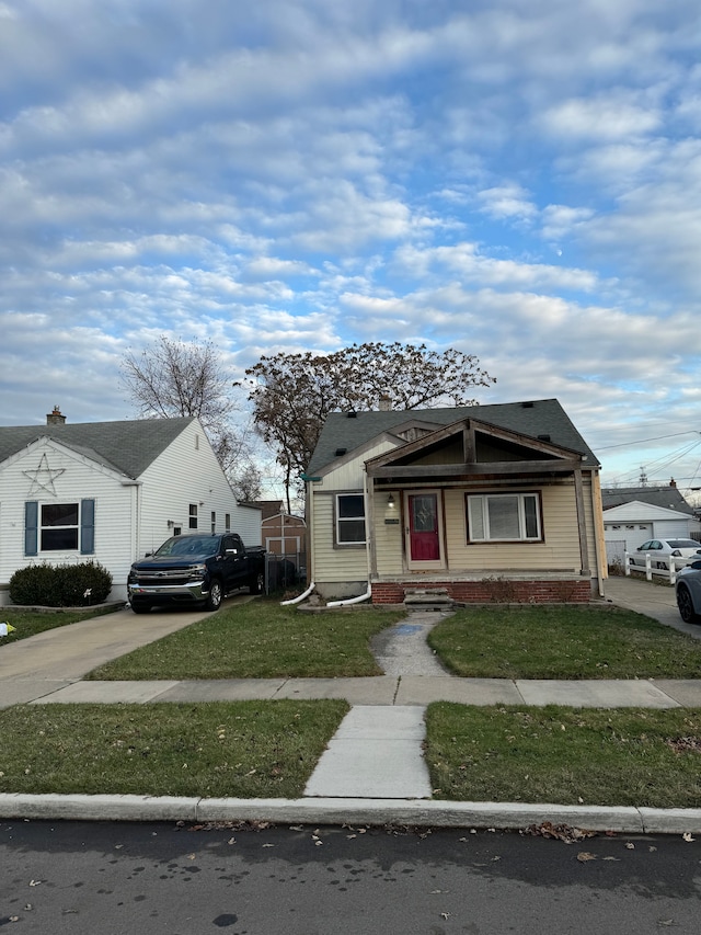 bungalow-style house with a front lawn