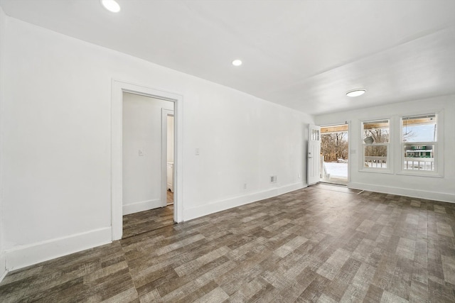 empty room with dark hardwood / wood-style flooring