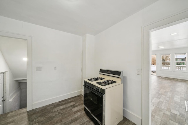 kitchen featuring dark hardwood / wood-style floors and gas range gas stove