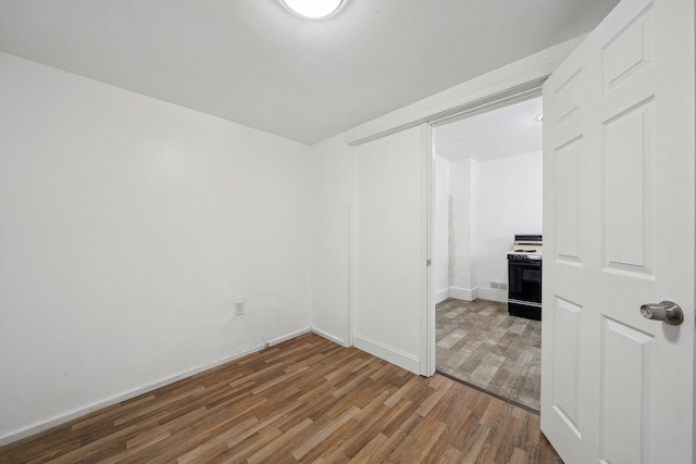 unfurnished room with wood-type flooring