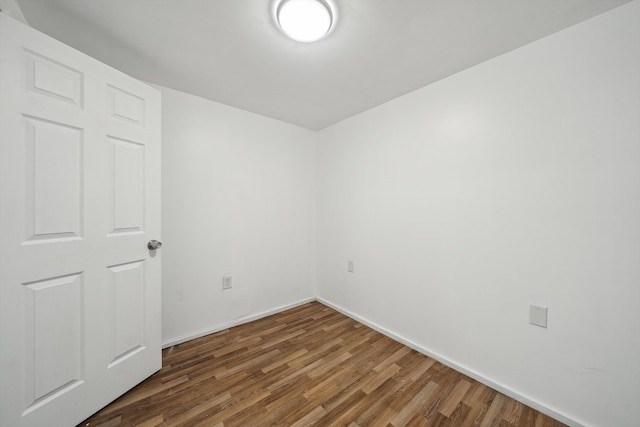 unfurnished room featuring dark hardwood / wood-style flooring