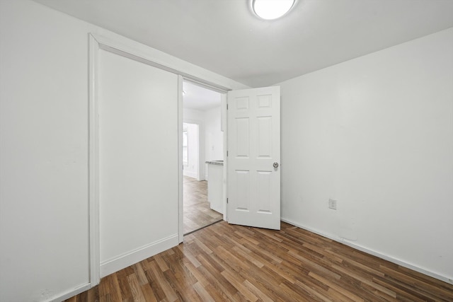 unfurnished bedroom featuring hardwood / wood-style flooring