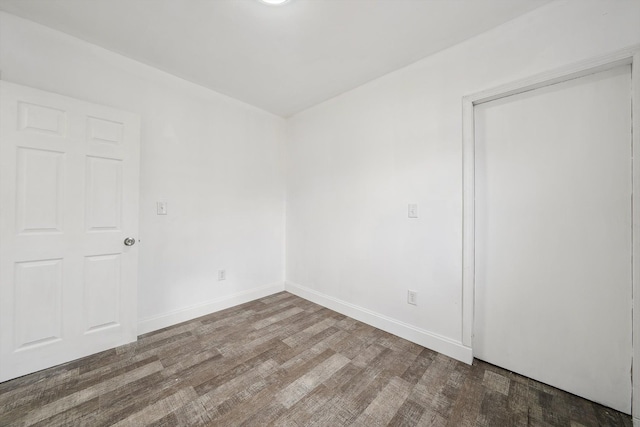 spare room featuring dark hardwood / wood-style flooring