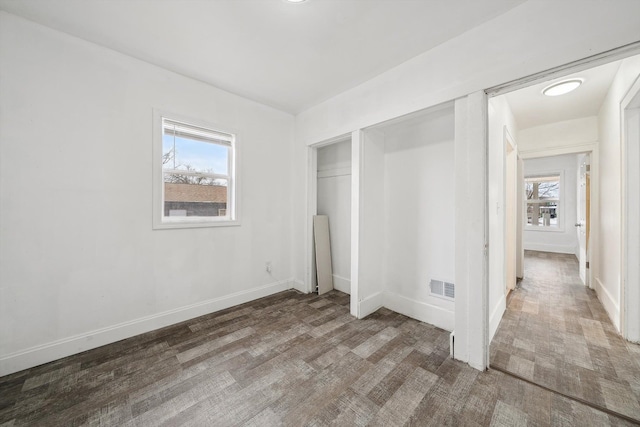 unfurnished bedroom with a closet and hardwood / wood-style floors