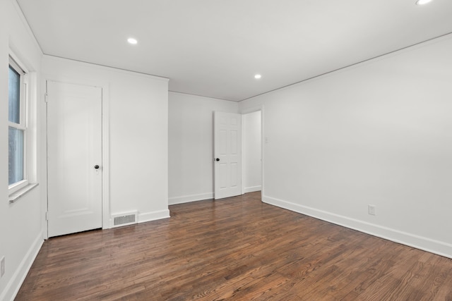 spare room with dark wood-type flooring