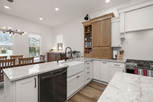 kitchen with dishwasher, white cabinetry, and light stone counters