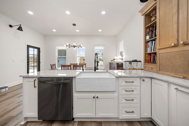 kitchen featuring dishwasher, white cabinetry, sink, kitchen peninsula, and light stone counters