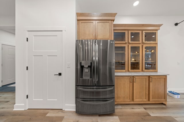 kitchen featuring stainless steel fridge and light wood-type flooring