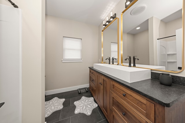 bathroom featuring tile patterned flooring and vanity