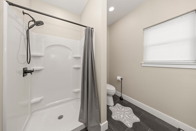 bathroom with toilet, walk in shower, and tile patterned floors