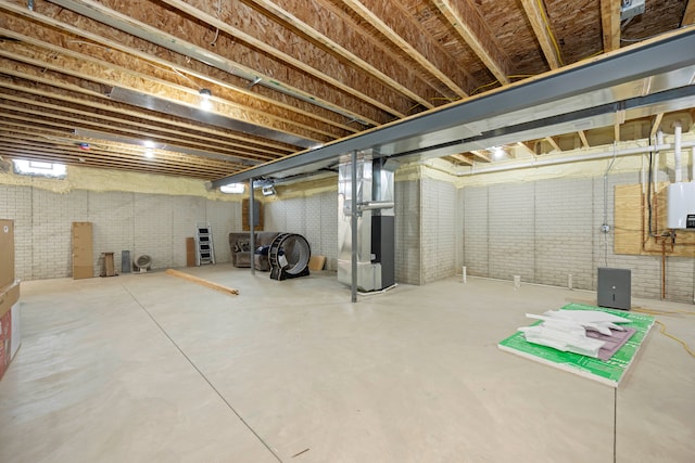 basement with heating unit and brick wall