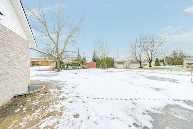 snowy yard with a storage unit