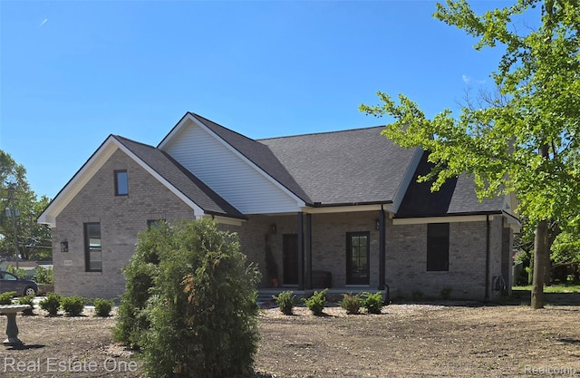 16185 Goddard Rd S, Southgate, MI 48195 - view of front of property featuring brick siding, covered porch, and a shingled roof
