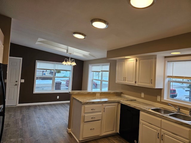 kitchen featuring decorative light fixtures, vaulted ceiling, black appliances, sink, and white cabinetry