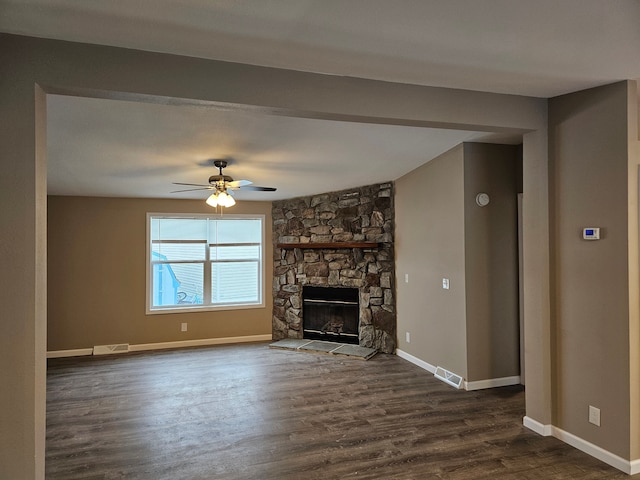 unfurnished living room featuring ceiling fan, dark hardwood / wood-style flooring, and a fireplace