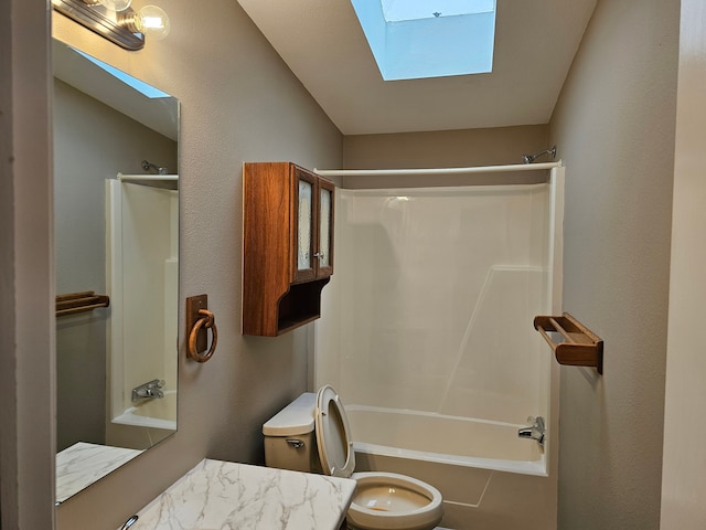 full bathroom featuring toilet, a skylight, shower / washtub combination, and vanity