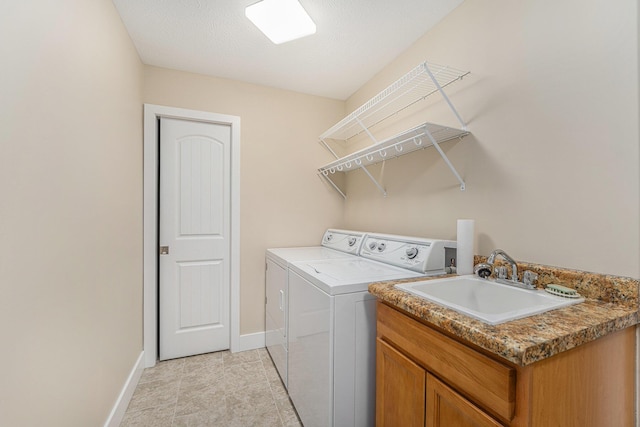 laundry room with independent washer and dryer and sink