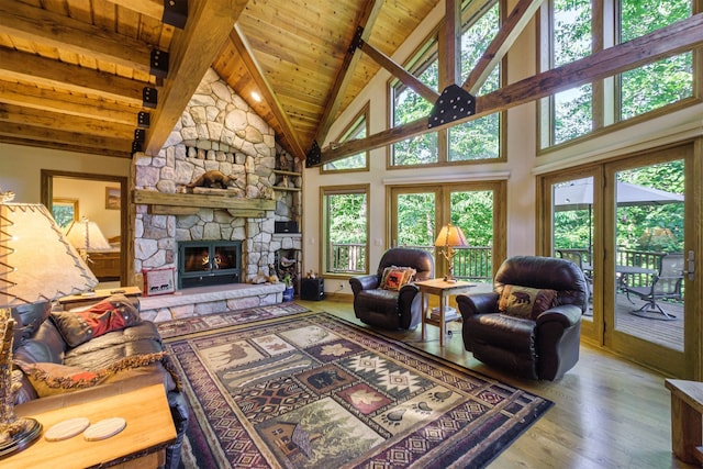 living room with a stone fireplace, wood ceiling, high vaulted ceiling, beam ceiling, and hardwood / wood-style floors