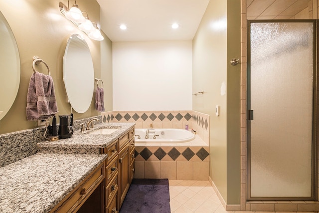 bathroom featuring plus walk in shower, tile patterned flooring, and vanity