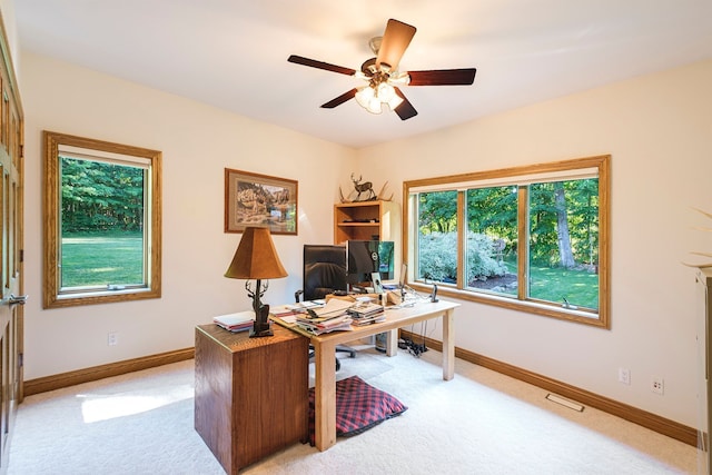 office space with light colored carpet and ceiling fan