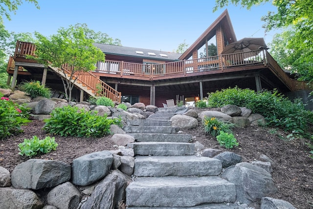 rear view of house featuring a wooden deck