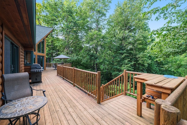 wooden deck featuring a grill