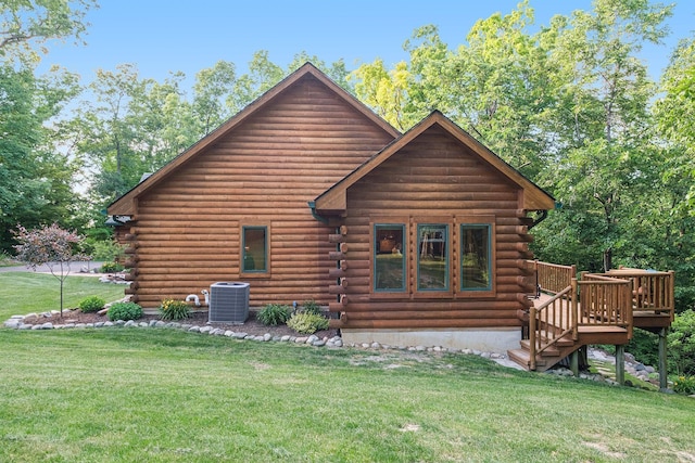 back of house with a deck, a yard, and central AC unit