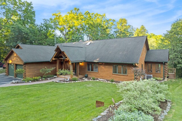 log cabin with a garage and a front yard