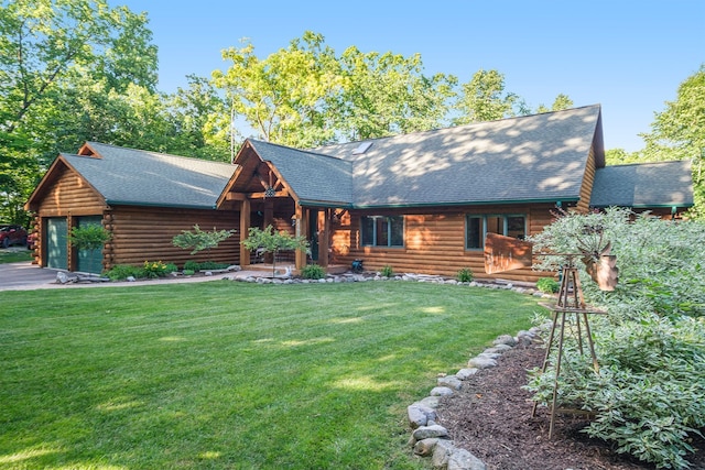 cabin featuring a garage and a front lawn