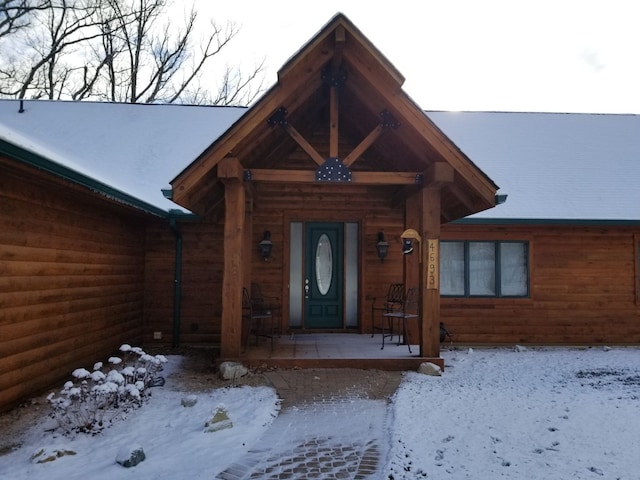 view of snow covered property entrance