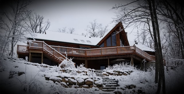 view of snow covered exterior featuring a deck