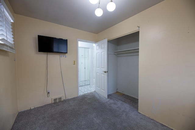 unfurnished bedroom with a closet and carpet