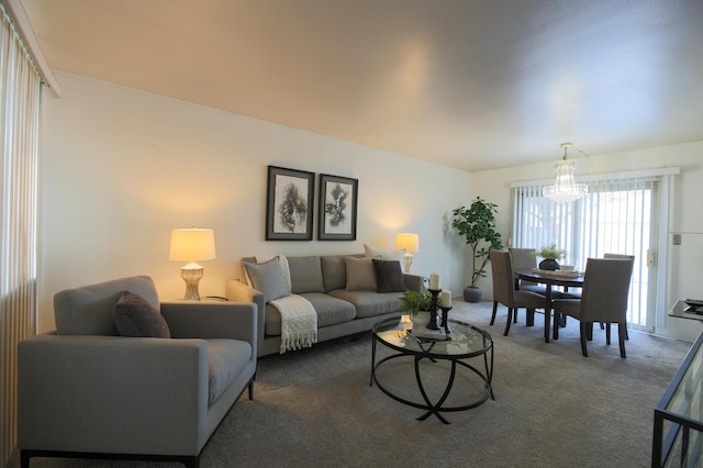 carpeted living room featuring a notable chandelier