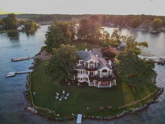 aerial view at dusk featuring a water view