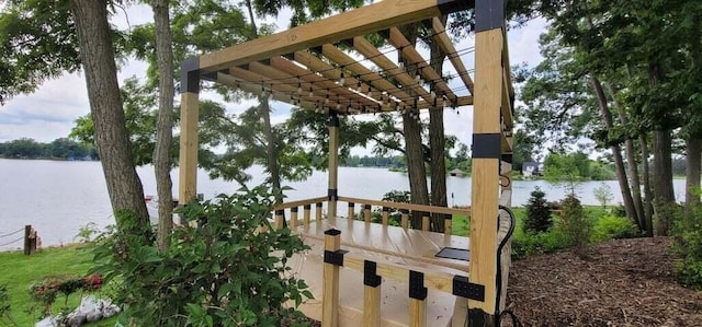 exterior space with a water view and a pergola