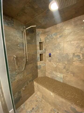 bathroom with a tile shower