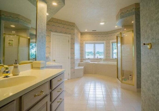 bathroom with tile patterned flooring, shower with separate bathtub, and vanity