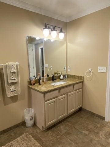 bathroom featuring crown molding and vanity