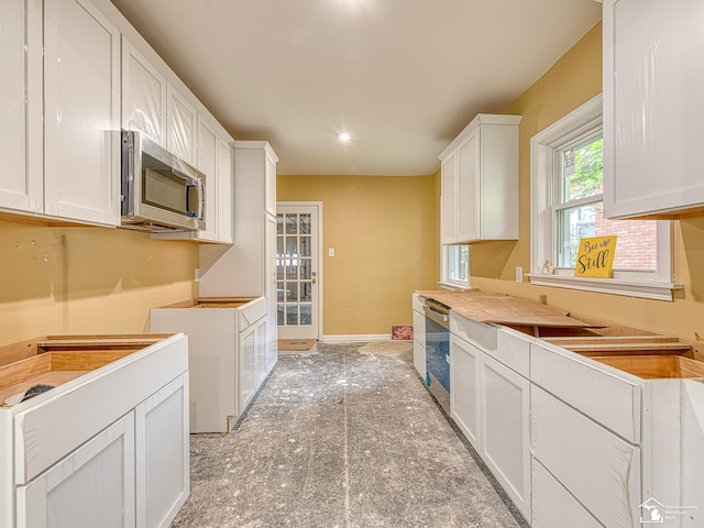 kitchen featuring white cabinets and appliances with stainless steel finishes